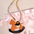 Équestre Leather Handbag Charm featuring a leather rocking horse design on a patterned strap.